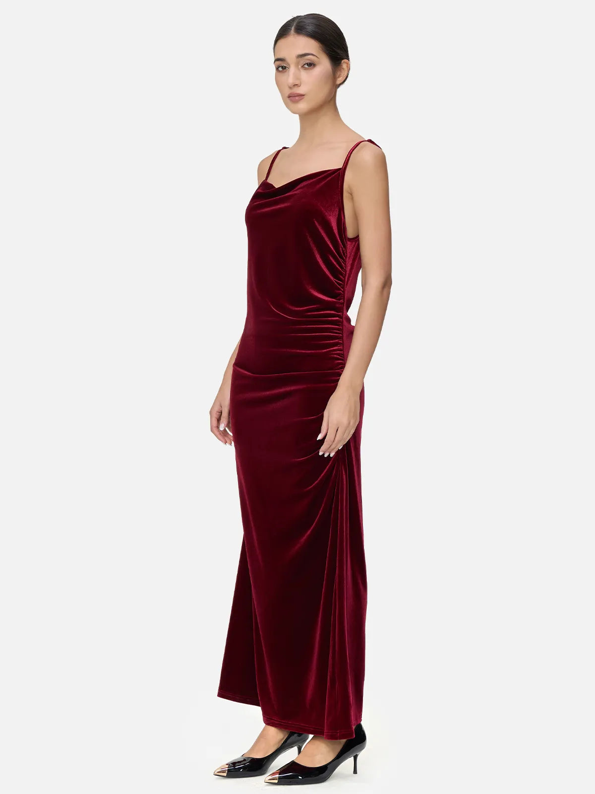 A velvet spaghetti strap maxi dress with irregular V-neck and pleated detailing, showcasing the graceful charm of women