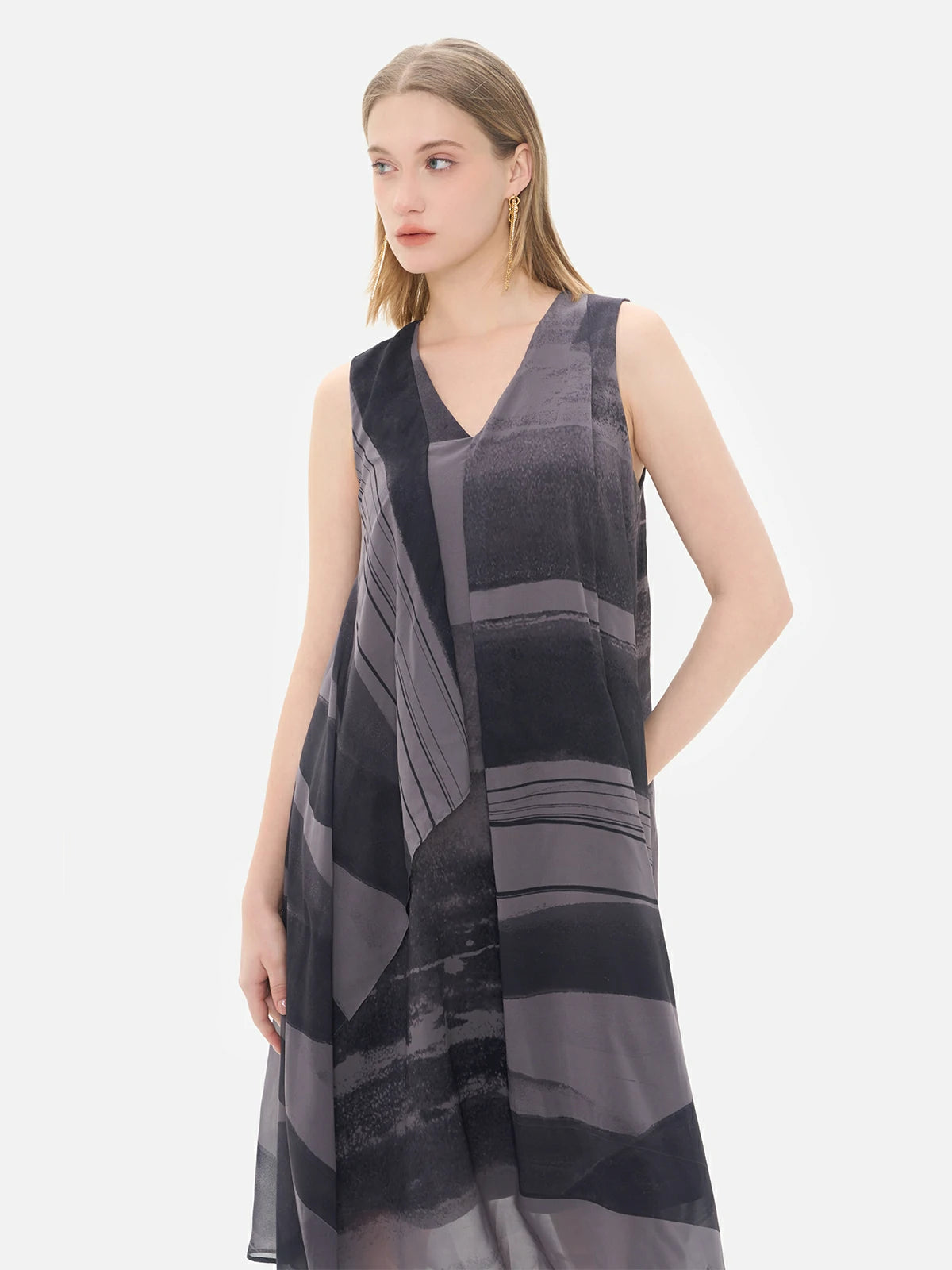Explore the versatility of this sleeveless chiffon dress, blending an artistic irregular print with a refreshing and airy design.