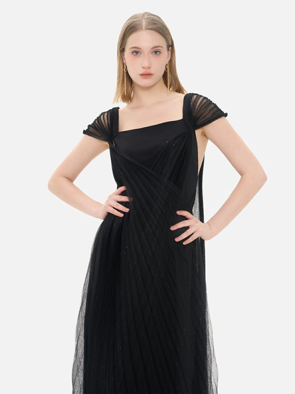 Striking evening gown in black, showcasing a sophisticated crisscross pleated mesh pattern, cap sleeves, and dazzling sequin details.