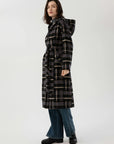 Long woolen coat with a coordinated belt, adding a touch of elegance