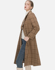 Make a statement with this belted brown double-breasted coat, boasting a flat lapel design, checkered pattern, and a tailored fit that enhances the feminine silhouette, ensuring confident and stylish wear.