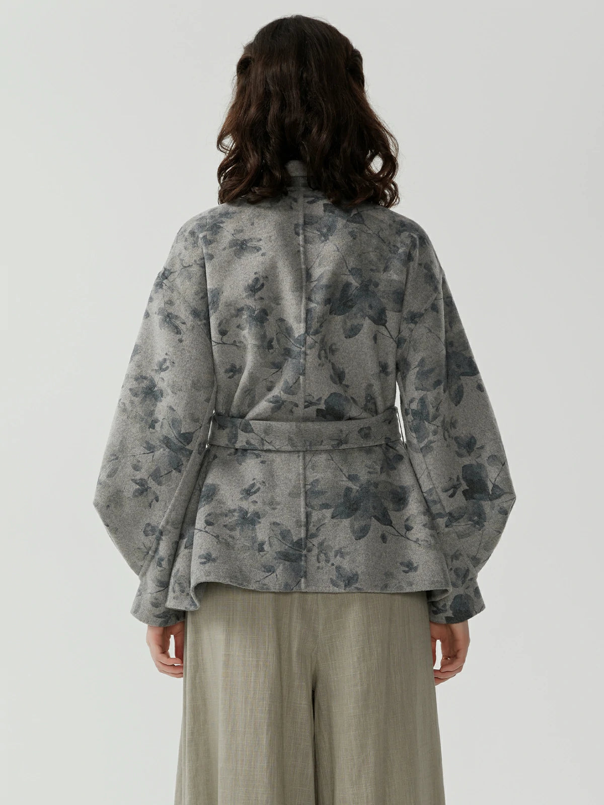 Collared jacket with accompanying belt, featuring grey printed pattern design and graceful fluid lines for a stylish look
