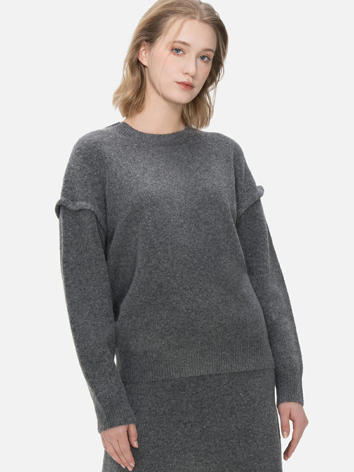 Redefine your knitwear collection with this versatile gray sweater, boasting a round-neck design and a simple yet stylish silhouette.
