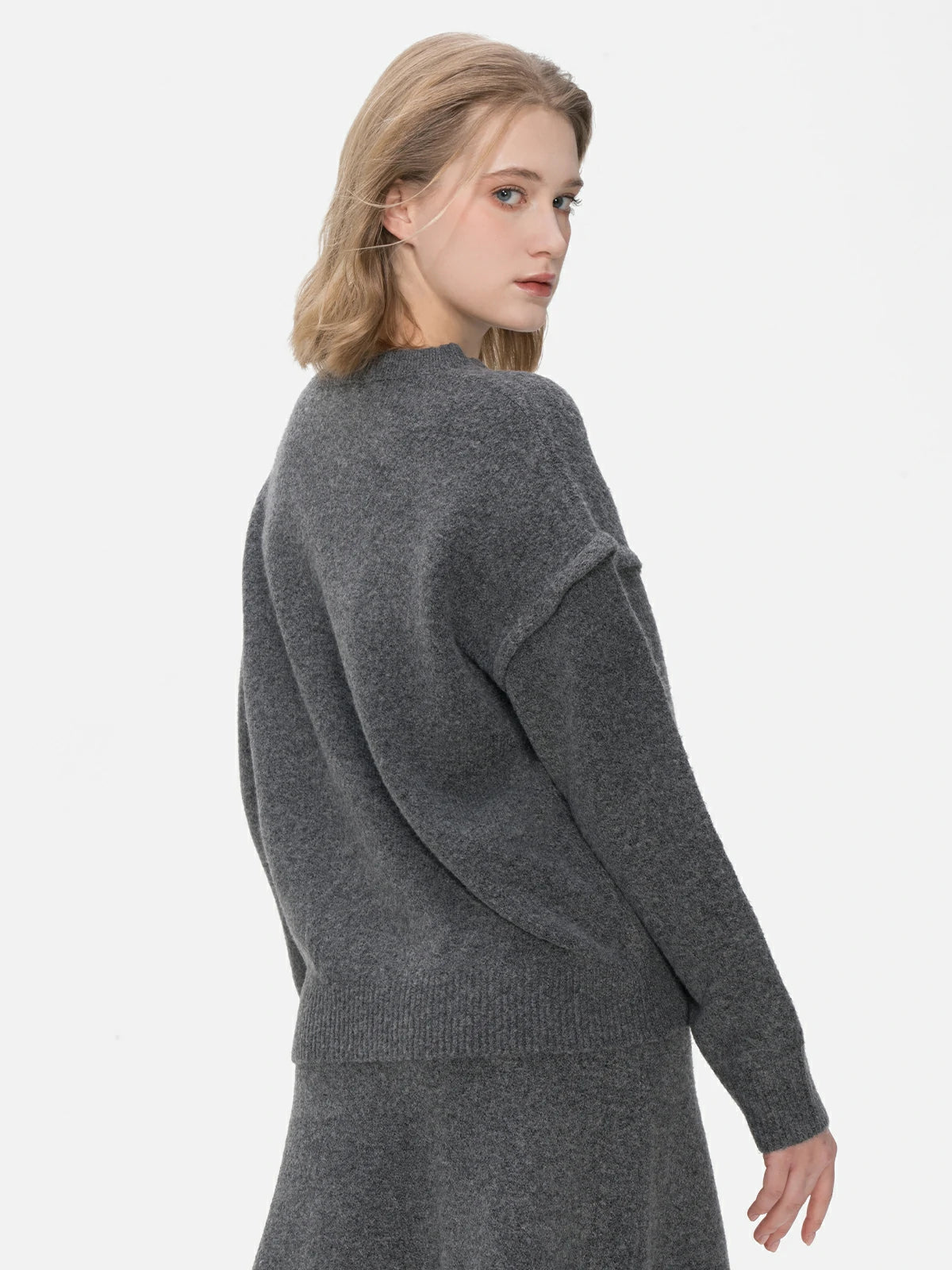 Elevate your casual elegance with this gray sweater, featuring a classic round-neck design, comfortable fit, and understated style.