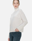Make a fashion statement with this classic and contemporary white turtleneck sweater, adorned with a turtleneck design and a snug fit.