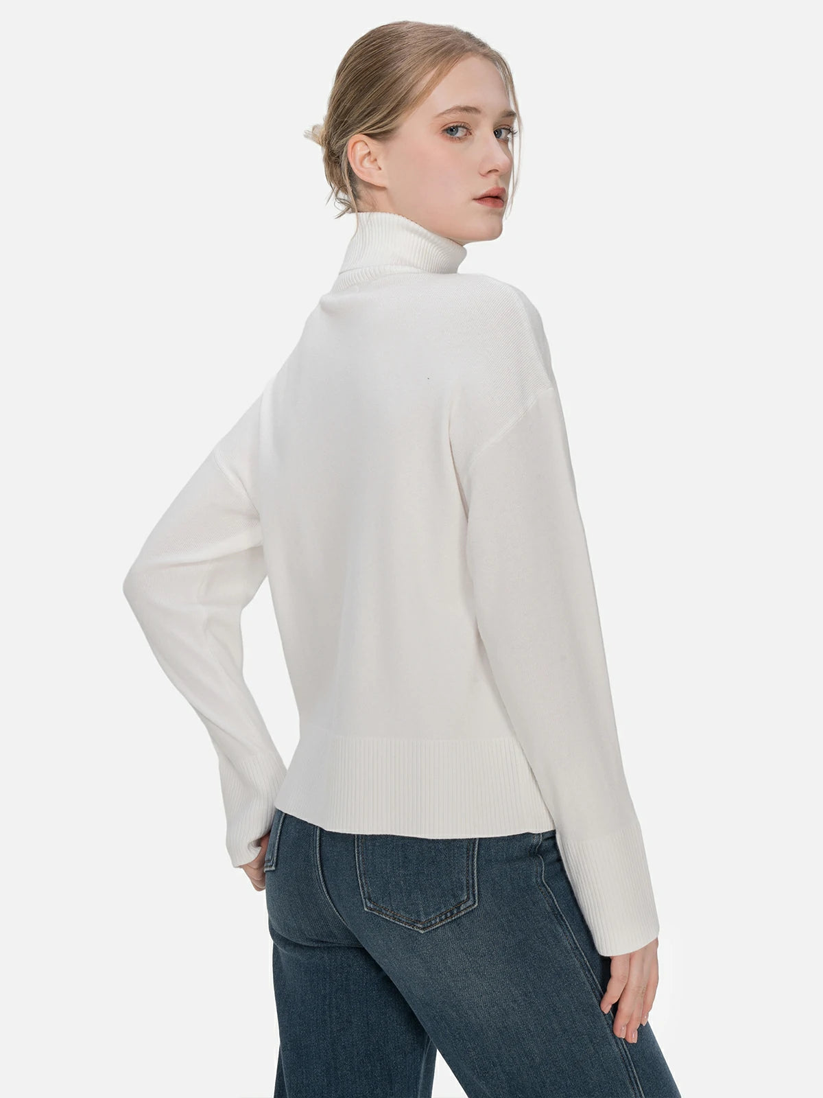Discover the perfect blend of comfort and style in this white turtleneck sweater, featuring an intricate knit texture and a snug fit.