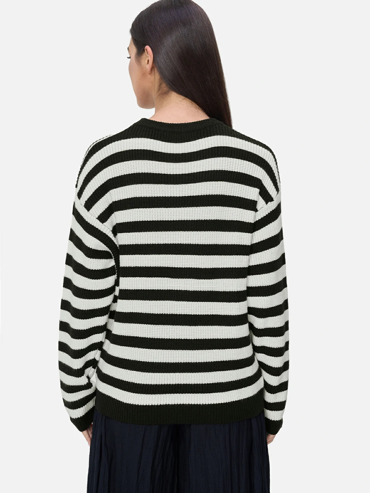 Embrace casual elegance with this dropped shoulder sweater, showcasing a ribbed knit texture and a classic black and white stripe pattern for a versatile and relaxed style.