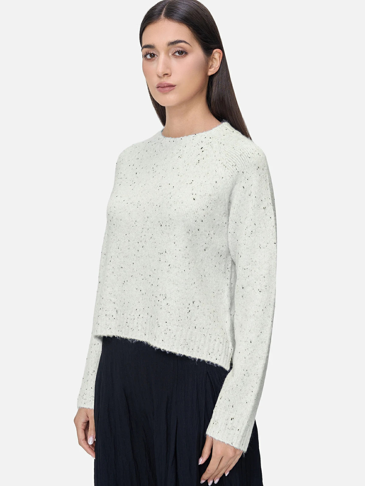 Elevate your wardrobe with this chic white crewneck sweater, adorned with delicate black polka dot embellishments for a stylish and playful look.