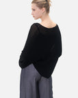 Lightweight and chic, this knitted pullover sweater boasts a front-short-back-long cut and an eye-catching cross-design.