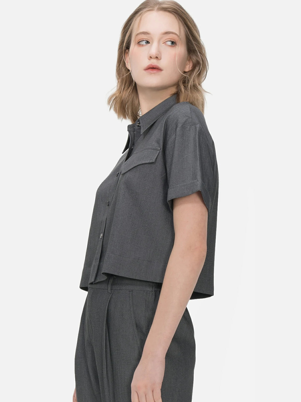 Unique lapel collar shirt with whimsical faux pocket patchwork and rolled cuff, offering a distinctive and stylish option for casual and relaxed summer occasions.