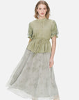Stylish short-sleeved blouse in green with a waist tie, accordion pleat detailing, and mesh bubble sleeves for a fashionable appearance.