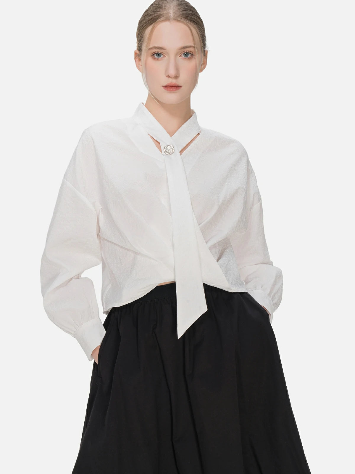 Stylish V-neck blouse with cascading ribbons, featuring a modern and elegant cross-pleat design for a uniquely charming appearance.