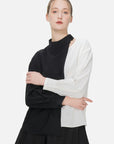 Stylish black and white color-blocked shirt featuring a collarbone hollow design.