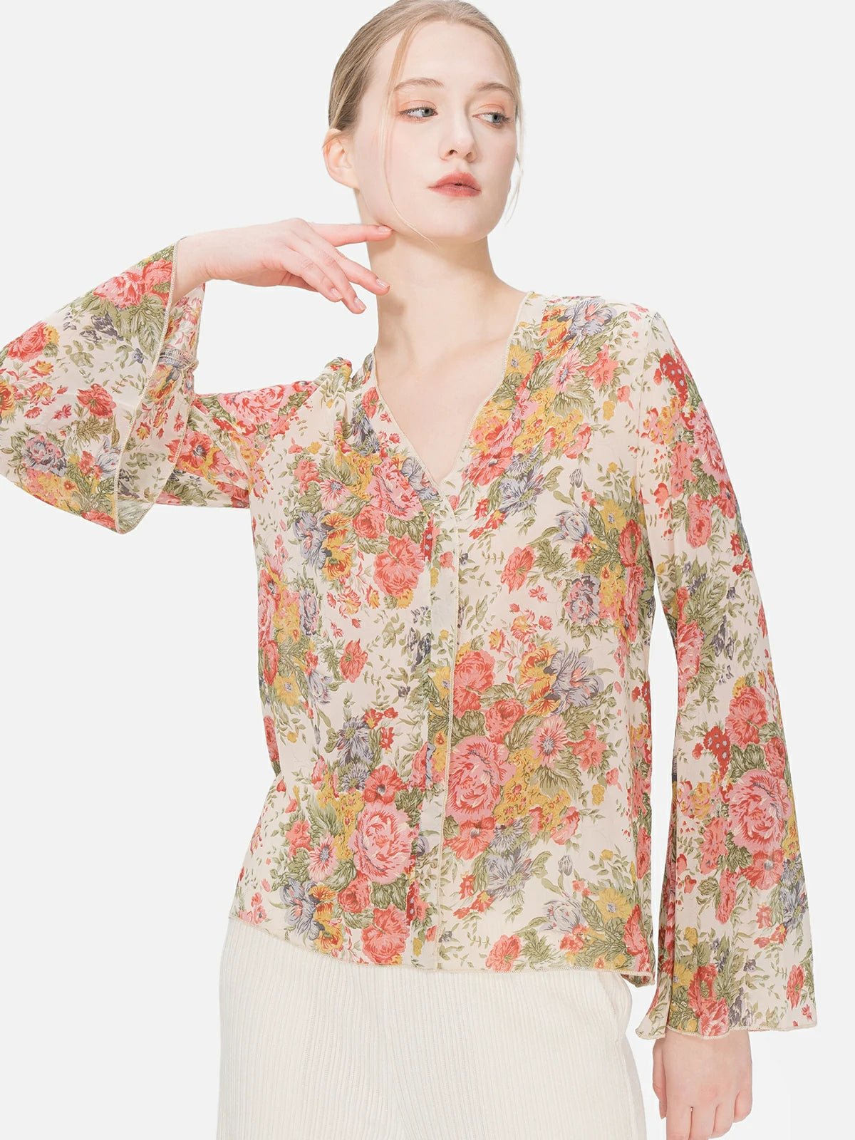Bohemian floral-print blouse with an ethereal feel, V-neck design, and lightweight texture, providing a comfortable and free-spirited fashion choice for casual and special occasions.