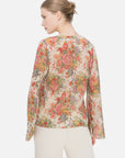 Feminine and romantic Bohemian blouse adorned with floral print, V-neck design, and lightweight fabric, offering a versatile and comfortable option for stylish everyday wear.