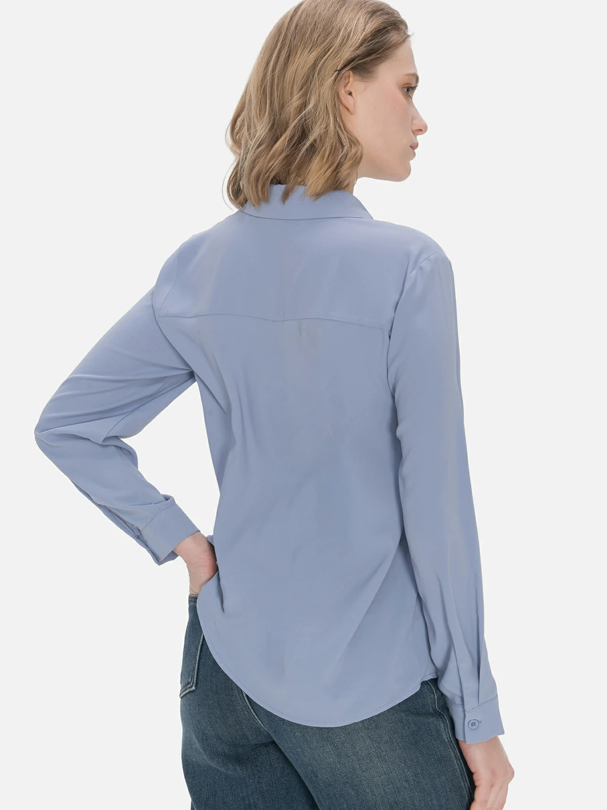 Delicate embellishments on a blue chiffon shirt with a turnover collar, creating an elegant and refined look suitable for both classic and casual outfits.