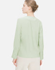 Discover the unique charm of this green chiffon blouse, featuring a V-neck design, pleated cuffs, and a refreshing color.
