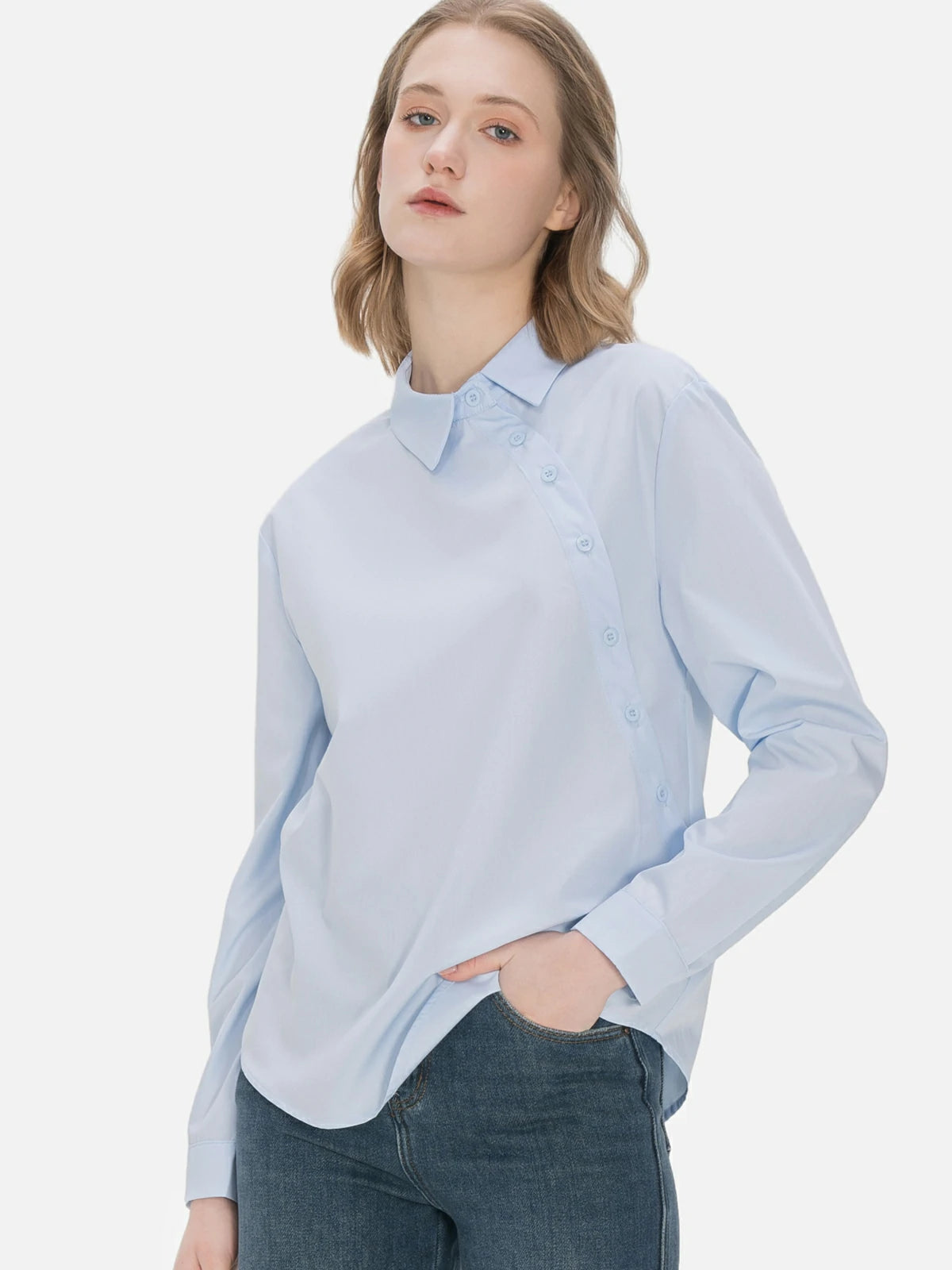 Tailored fit ladies&#39; shirt featuring a diagonal button design and timeless blue color, offering a comfortable and refined option for both formal and casual settings.