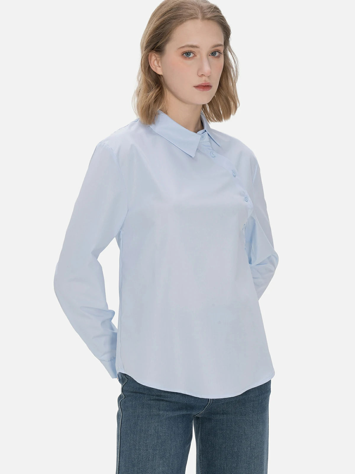 Classic blue ladies&#39; collared shirt with an elegant diagonal button design, tailored to provide a stylish and comfortable fit for different occasions.