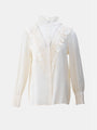 Vintage-inspired white ruffled blouse with lace details and high neckline