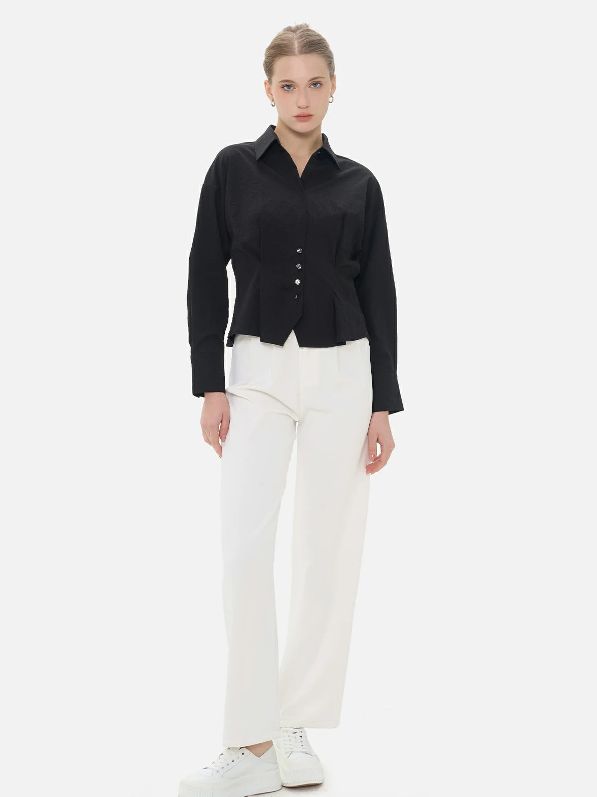 Elegant and refined women&#39;s shirt with a textured surface and cinched waist