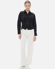 Elegant and refined women's shirt with a textured surface and cinched waist