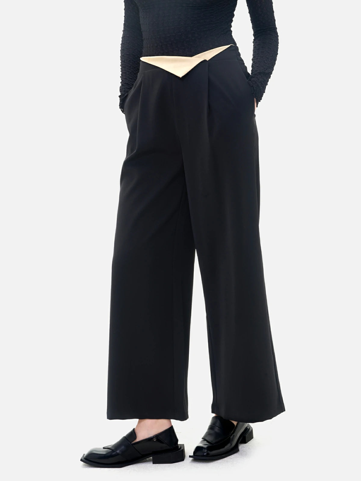 Stylish black wide-leg pants with a waistband flip and color-blocking design