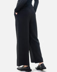 Uniquely designed black wide-leg pants with a waistband flip and color-blocking detail, adding a vibrant touch to the overall look