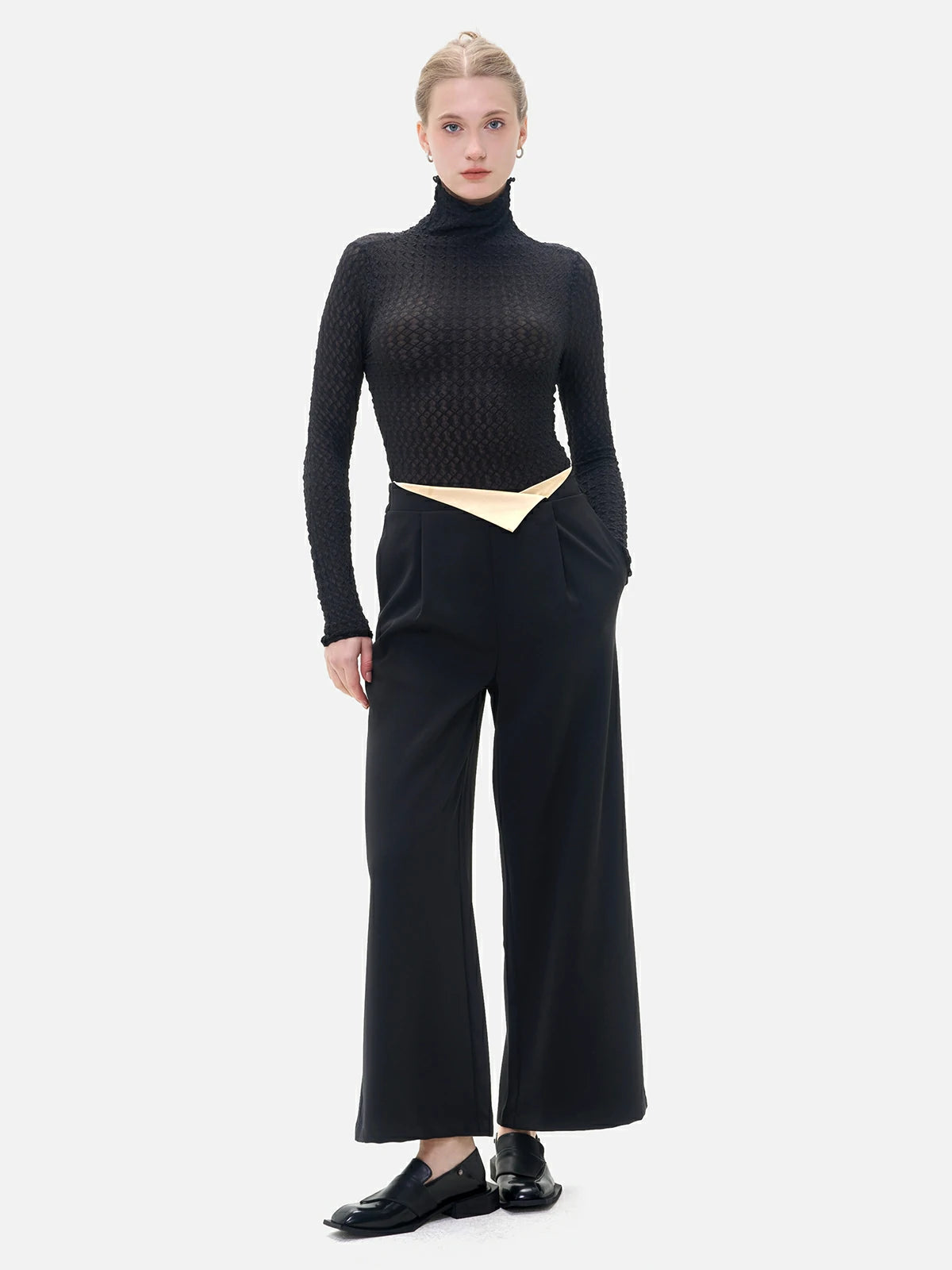 Fashionable wide-leg pants with a distinctive color-blocking flip at the waist, elevating the style quotient