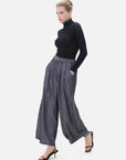 Feminine curve accentuation in trousers with elastic, button, and pleat designs