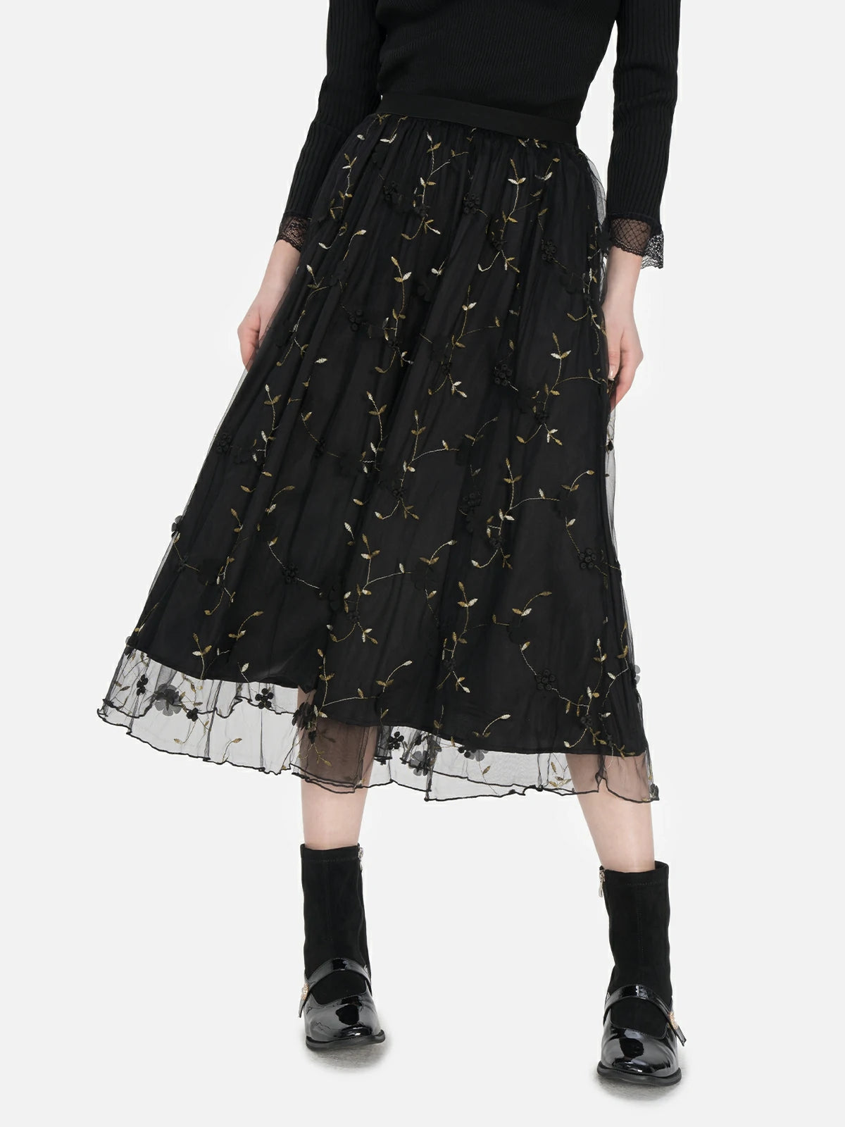 Unique midi tulle skirt with high waist and embroidered leaf patterns, perfect for creating an elegant and romantic ensemble.