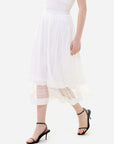 Feminine elegance and curves in a white skirt hem