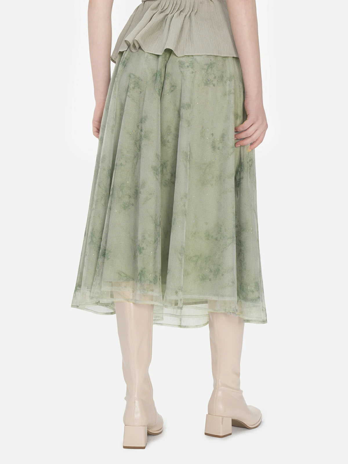 Elegant A-line midi skirt in green with an elastic waistband, crafted from sheer mesh fabric showcasing subtle and delicate floral prints, creating a mysterious and feminine allure.