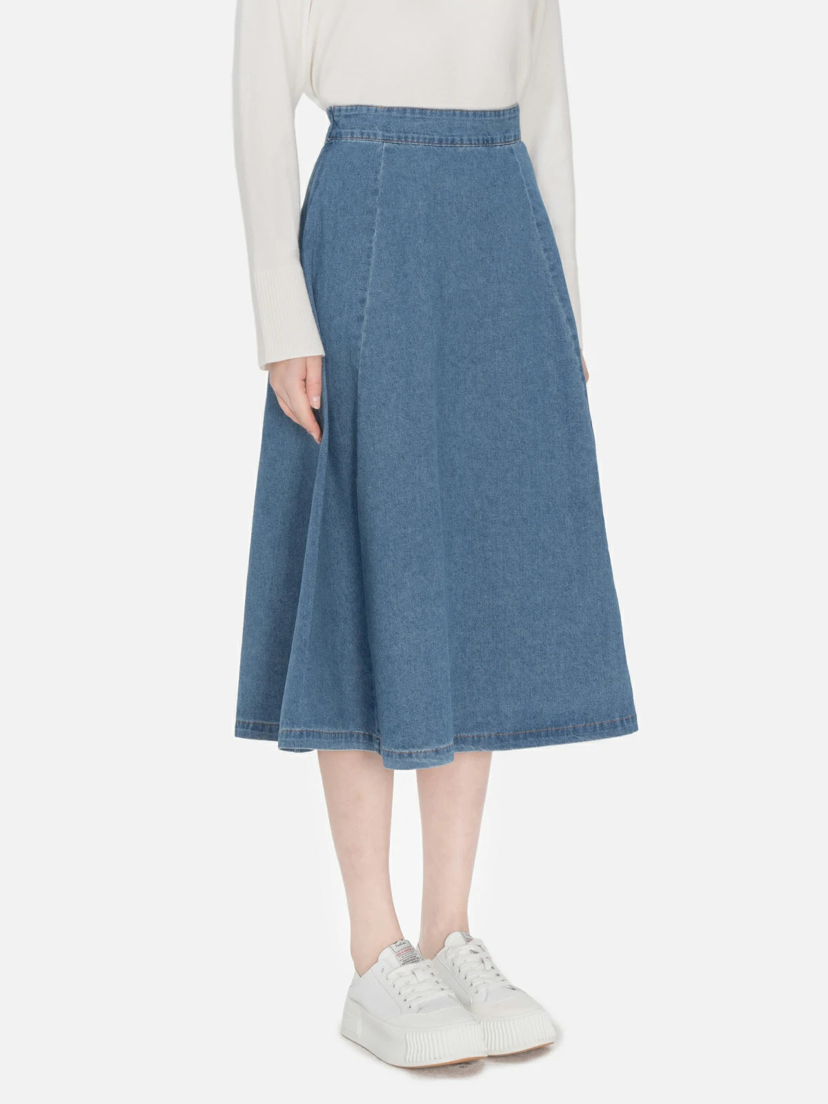 Versatile blue denim skirt featuring a classic A-line cut, and high waist, providing a comfortable and durable option suitable for various occasions.