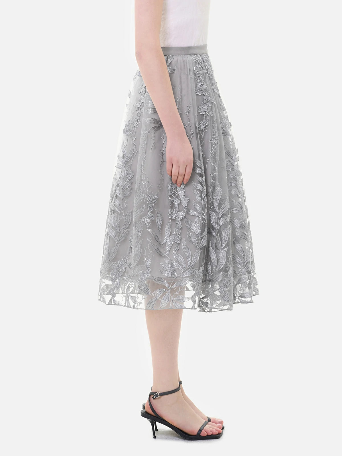 Experience the versatility of this elegant A-line tulle skirt with its embroidered floral design and sequin embellishments.