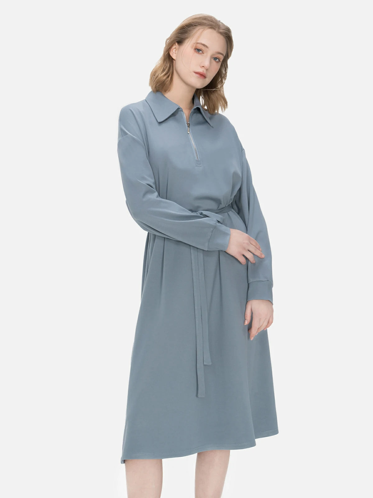 Tailored fit midi dress with a belted waist, collar, and front zipper detailing, combining comfort and style seamlessly.