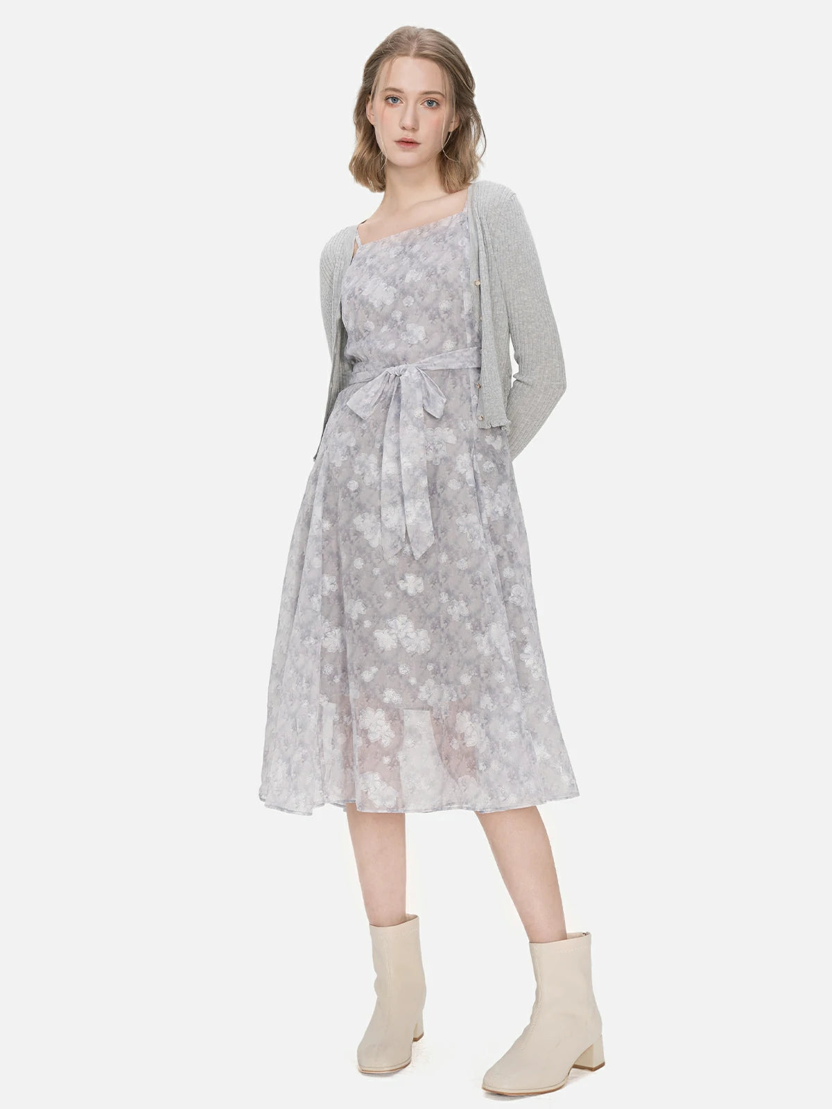 Step into the spotlight with this versatile two-piece set, featuring a V-neck knit cardigan adorned with ruffle hem and buttons, and a spaghetti strap floral chiffon dress.