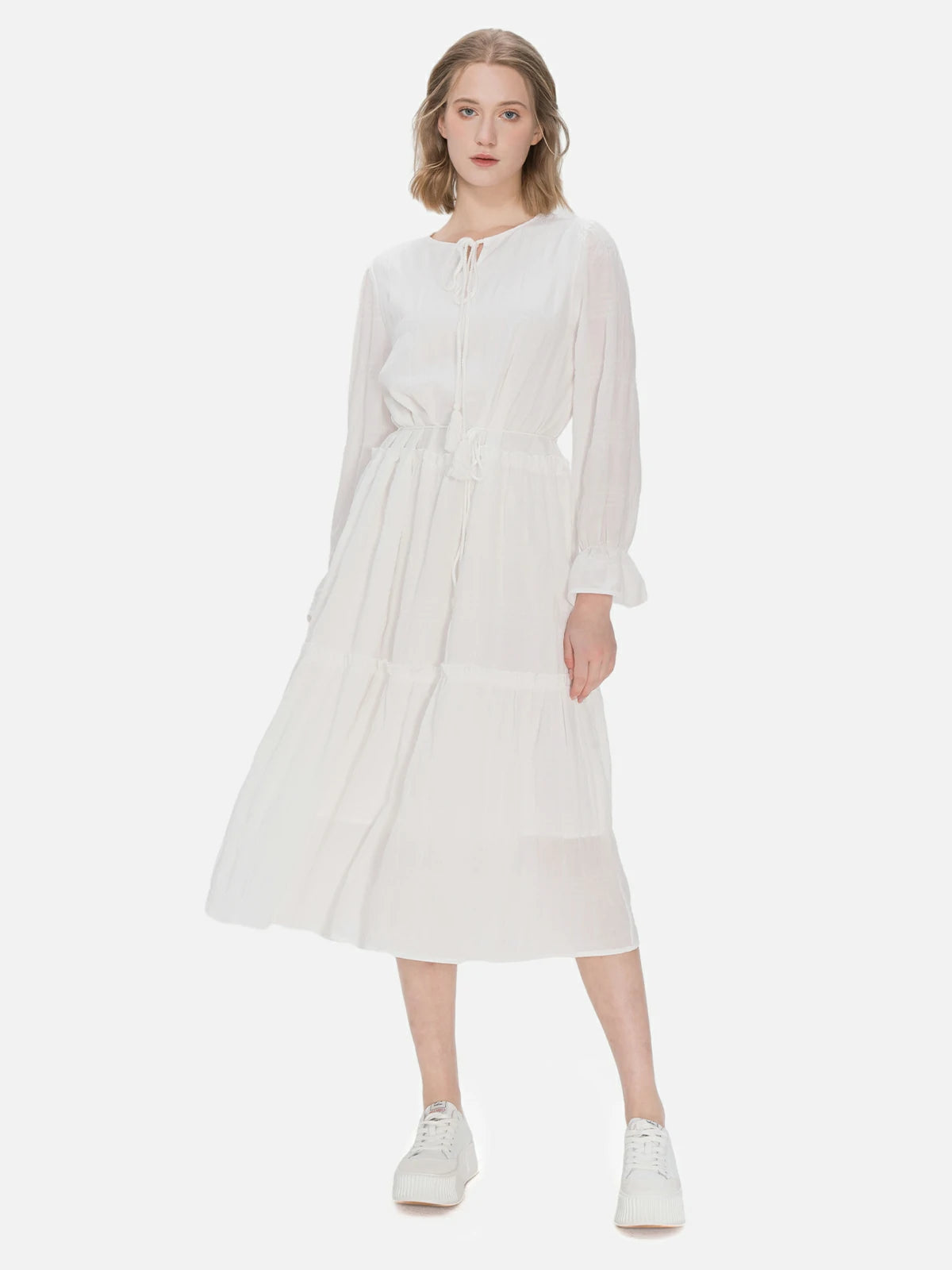 Elegant mid-length dress in fresh white design with neckline and waist tie details, perfect for a versatile and fashionable look.