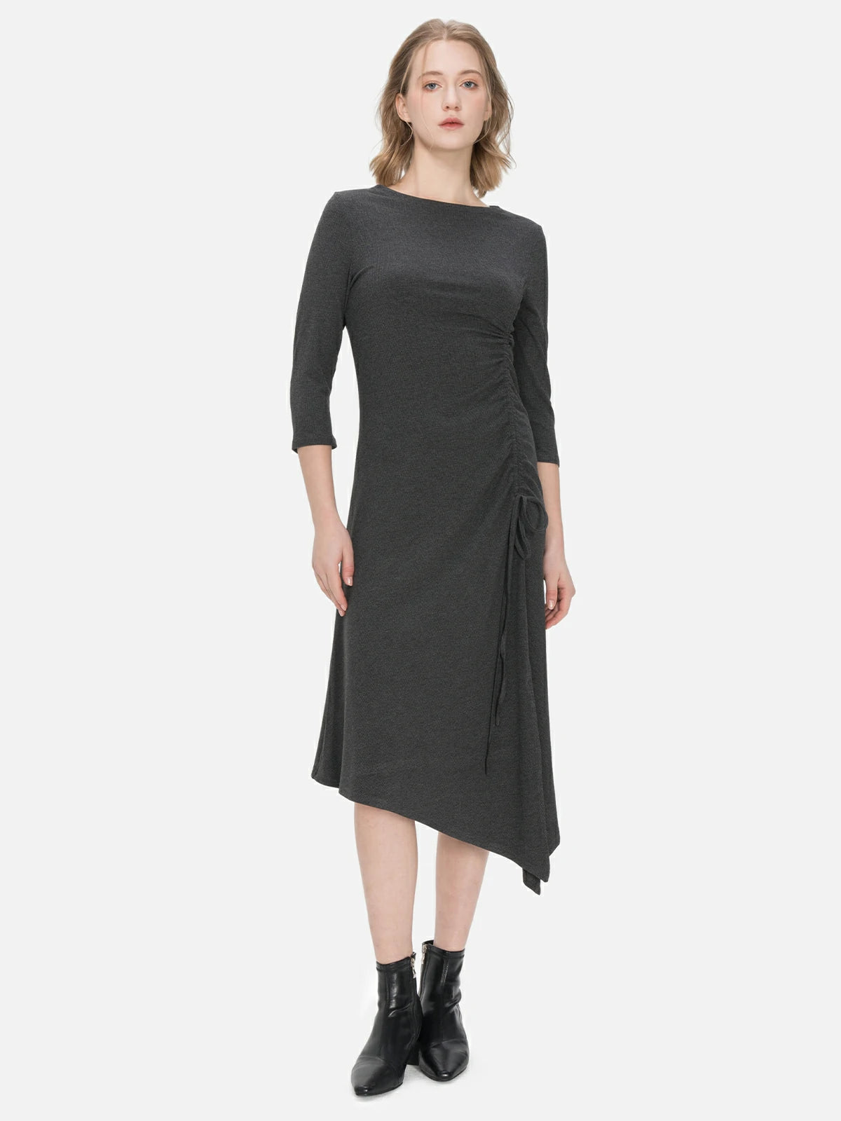 Stylish black knitted dress with an irregular hem, side slit, and drawstring design, offering a comfortable and fashionable silhouette suitable.