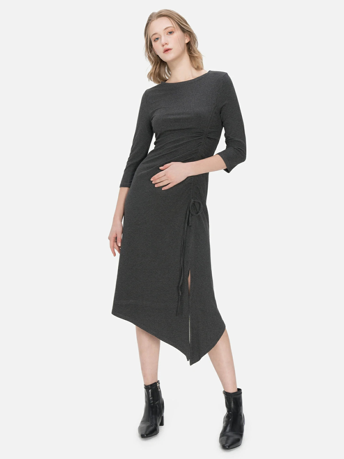 Comfortable and chic dark gray knitted dress featuring an irregular hem, side slit, and drawstring design, ensuring both a fashionable appearance and freedom of movement.