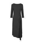 Black knitted dress designed with an irregular hem, side slit, and drawstring detail, providing both elegance and freedom of movement.