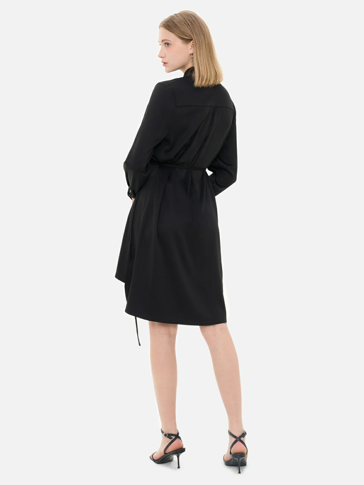 Redefine your wardrobe with this fashionable and unique black shirt dress, showcasing a waist-tie accent, irregular hem, and front ruffle paneling.