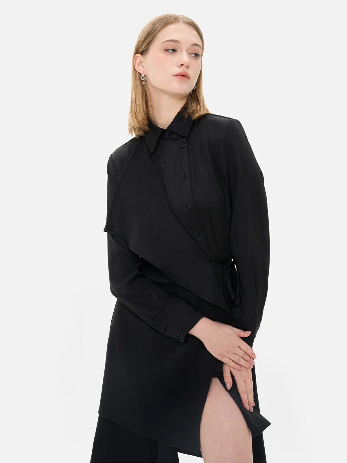 Infuse your look with sophistication in this black shirt dress featuring a waist-tie accent, irregular hem, and front paneling.