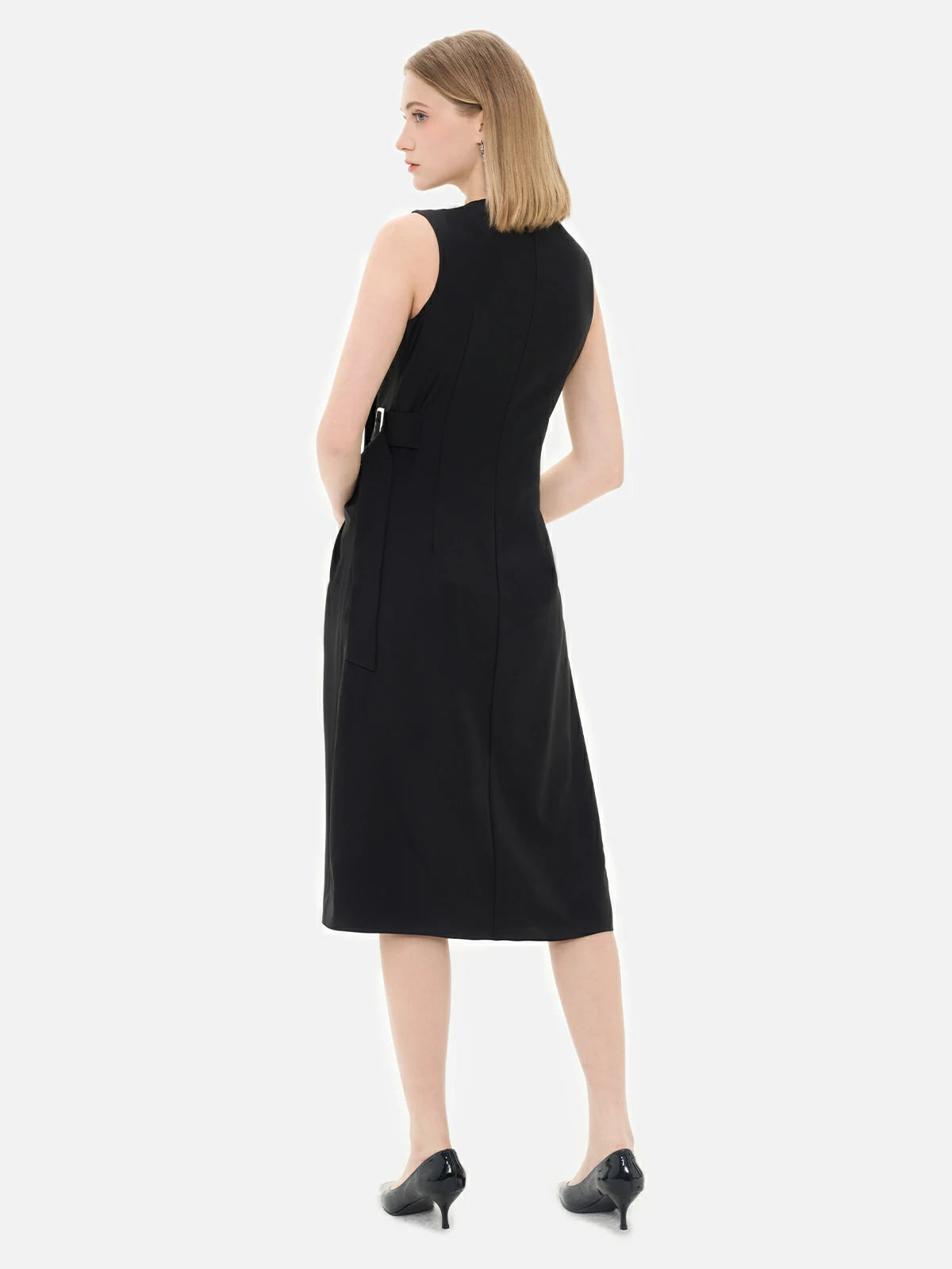 black dress with sleek, modern silhouette and statement belt detail