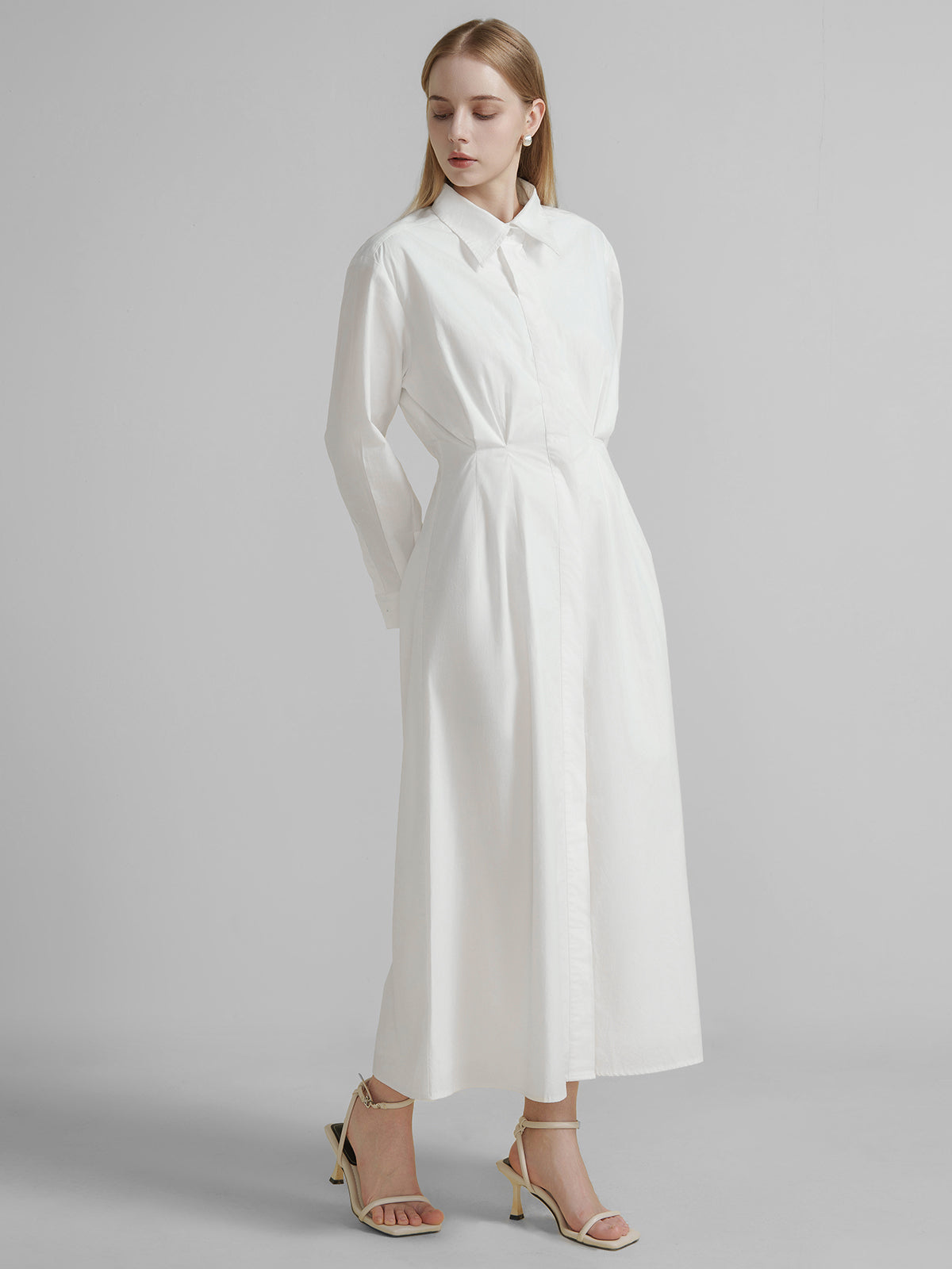 S·DEER white long shirt dress, showing its streamlined silhouette and elegant pleating, ideal for a smart-casual look or daytime events