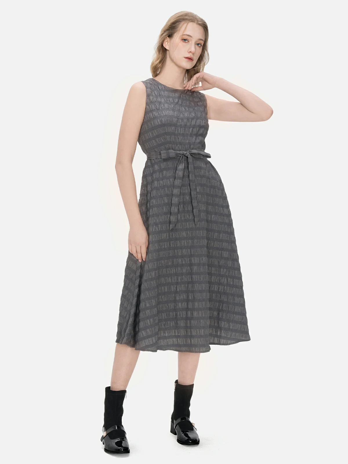Showcase your individuality with this avant-garde ensemble, combining an irregular buttoned cardigan and a sleeveless A-line dress with a textured stripe design.