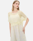Elegant apricot-toned women's dress with an artistic ambiance.