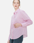 Make a fashion statement with this versatile two-piece set, combining a pink pinstripe shirt with a V-neck knit vest.