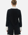 Classic and crisp white shirt elements in black knitted top