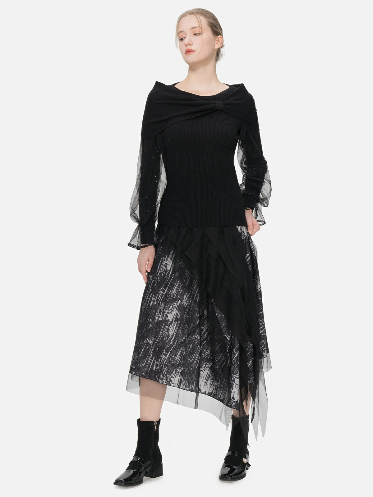 A fitted sweater featuring a unique one-shoulder bow shawl and delicate splice tulle sleeves, combining fashion-forward details with a comfortable fit.